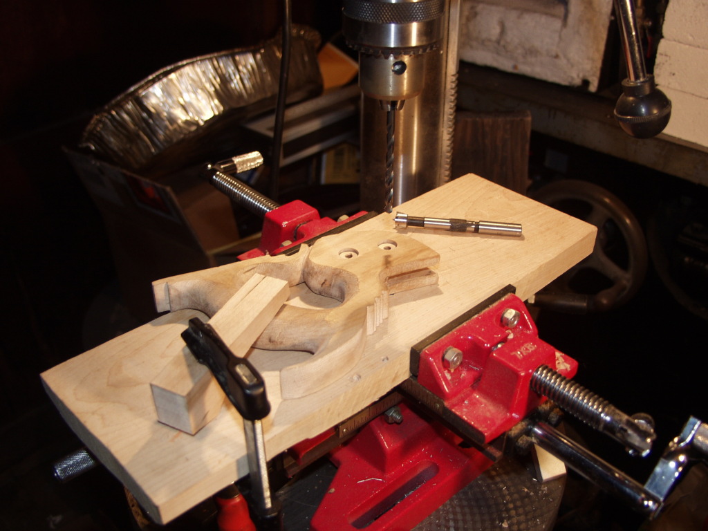 Drilling the holes for the split-nuts, I then dry fit the saw, use a centering punch to mark them, and use a punch to put the hole in the blade. You can drill them also, that works fine.